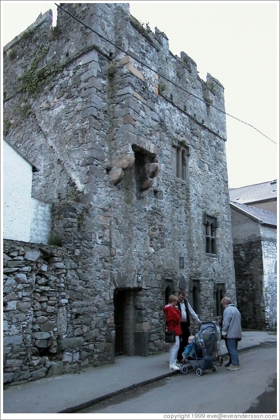 People hanging out in front of some ruins.