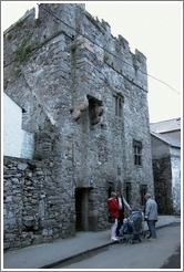 People hanging out in front of some ruins.