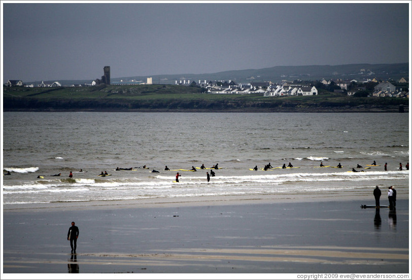 Lahinch Beach, with surfers from a surfing school.