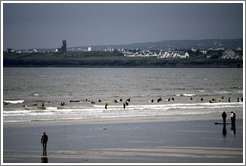 Lahinch Beach, with surfers from a surfing school.