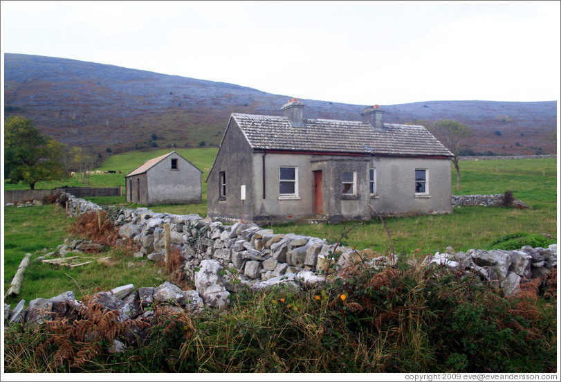 House with stone fence.