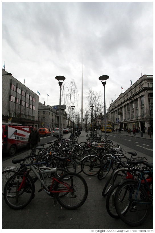 The Spire, behind bicycles and statue of James Larkin.  O'Connell St.