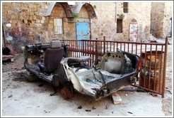 Destroyed vehicle in a courtyard, old town Akko.