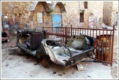 Destroyed vehicle in a courtyard, old town Akko.