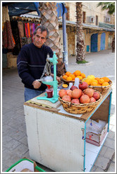 Man making pomegranate juice, old town Akko.