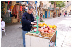 Man making pomegranate juice, old town Akko.