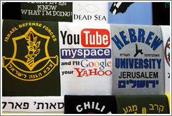T-shirts for sale in the souk, one of which says: "YouTube myspace and I'll Google your Yahoo".  Christian Quarter, Old City of Jerusalem.