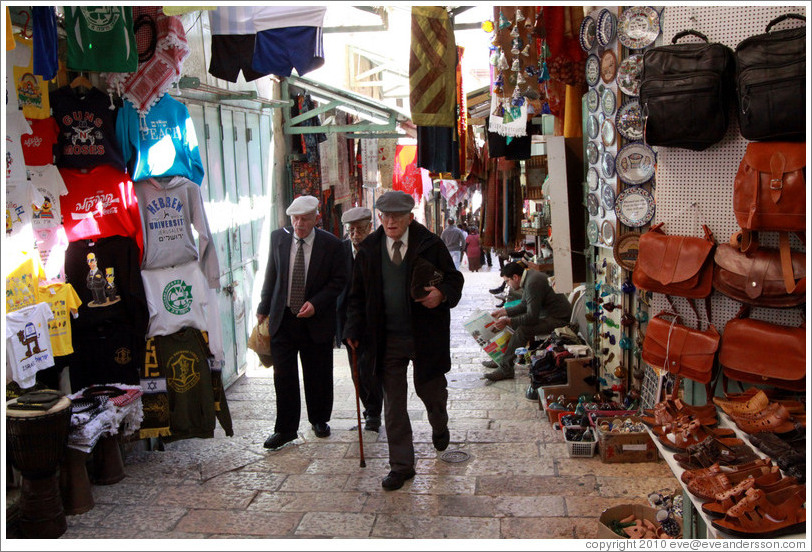 Three men walking down David Street, Christian Quarter, Old City of Jerusalem.