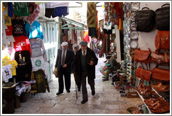 Three men walking down David Street, Christian Quarter, Old City of Jerusalem.