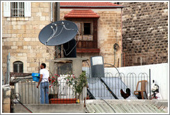 Man and rooster on a roof, viewed from the Austrian Hospice of the Holy Family.