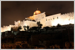 Night view of a dome and walls of the Old City of Jerusalem.