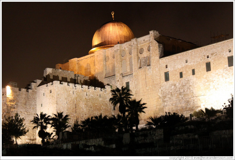 Night view of a dome and walls of the Old City of Jerusalem.