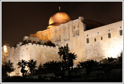 Night view of a dome and walls of the Old City of Jerusalem.