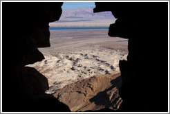 View of the desert and dead sea through a hole in the South Gate, desert fortress of Masada.