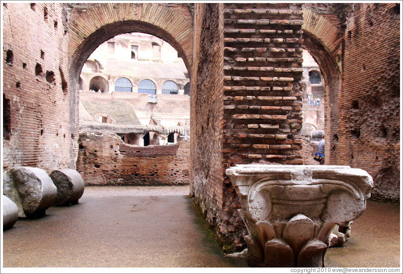 Arches and the top of an Ionic column.  The Colosseum.