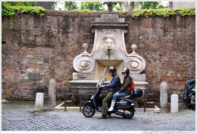 Scooter riders in front of Fontana del Mascherone (Fountain of the Mask) (1626).