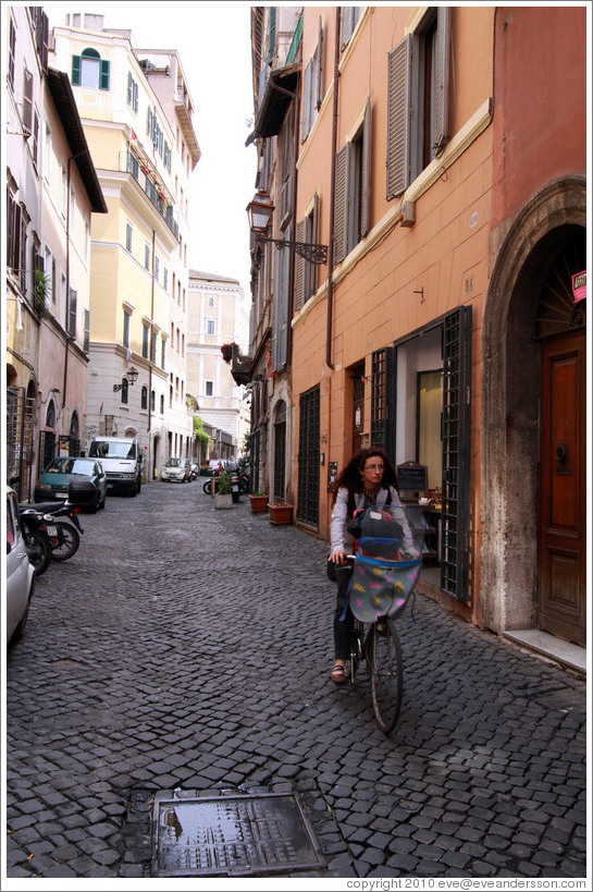 Woman riding bicycle on Via del Pellegrino.