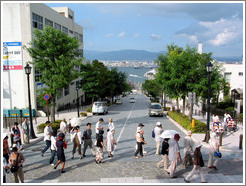 Tourists on street overlooking bay.