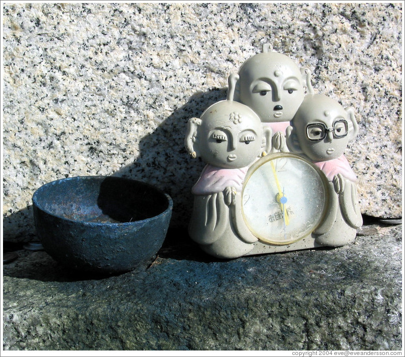 Offering.  Three-alien alarm clock.  Mt. Osorezan.