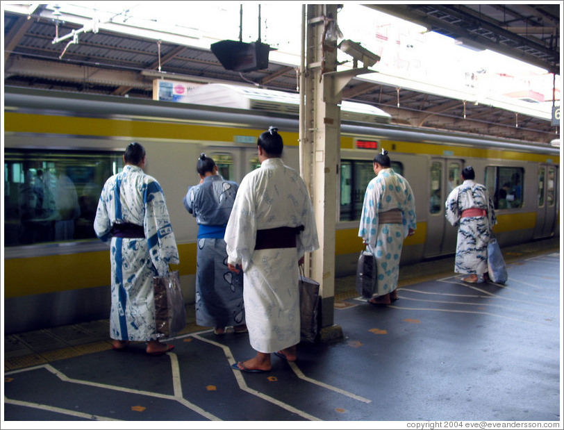 Sumo wrestlers waiting for the JR train.
