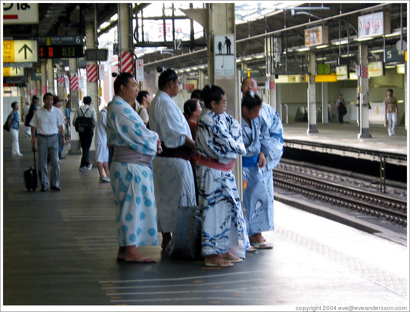 Sumo wrestlers waiting for the JR train.