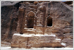 Stone wall with votive niches carved into it.