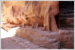 The remains of a sculpture depicting a man and a camel.