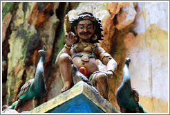 Male figure with peacocks, roof of temple, 2nd level, Batu Caves.