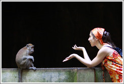 Monkey and girl conversing, Batu Caves.