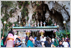 People and statues at the entrance to Batu Caves.