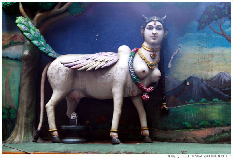 Figure, part woman and part animal, over stairway to Batu Caves.