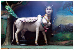 Figure, part woman and part animal, over stairway to Batu Caves.