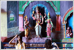 Women in front of statues, Batu Caves.