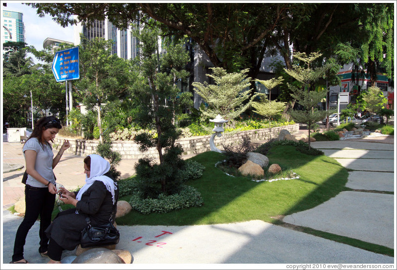 Two women beside a small garden, Jalan Raja Chulan.