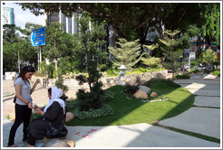 Two women beside a small garden, Jalan Raja Chulan.