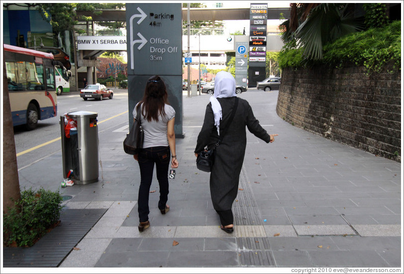 Two women walking down Jalan Raja Chulan.