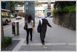 Two women walking down Jalan Raja Chulan.