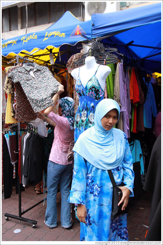 Woman in front of a mannequin at the market on Lorong Tuanku Abdul Rahman.