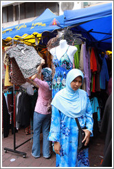 Woman in front of a mannequin at the market on Lorong Tuanku Abdul Rahman.