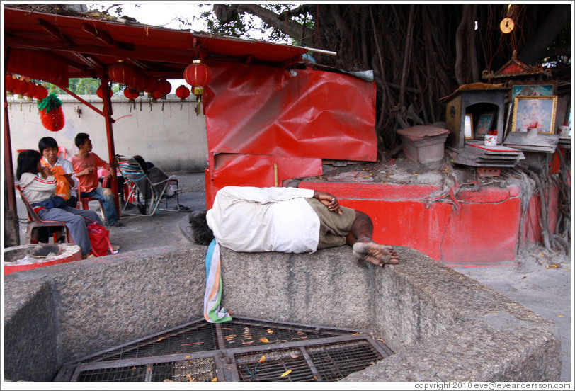 Man sleeping outside Kuan Yin Teng (Temple of the Goddess of Mercy).