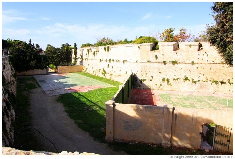Moat around the city walls, with tennis courts in it.
