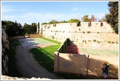 Moat around the city walls, with tennis courts in it.