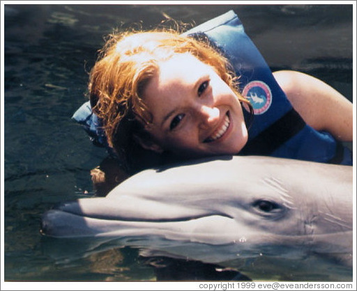 Eve swims with the dolphins. Xcaret.