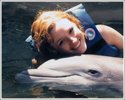 Eve swims with the dolphins.  Xcaret.