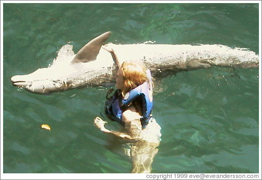 Eve swims with the dolphins.  Xcaret.