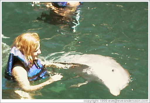 Eve swims with the dolphins.  Xcaret.