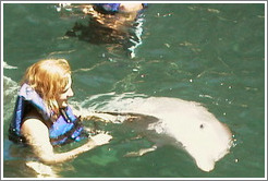 Eve swims with the dolphins.  Xcaret.