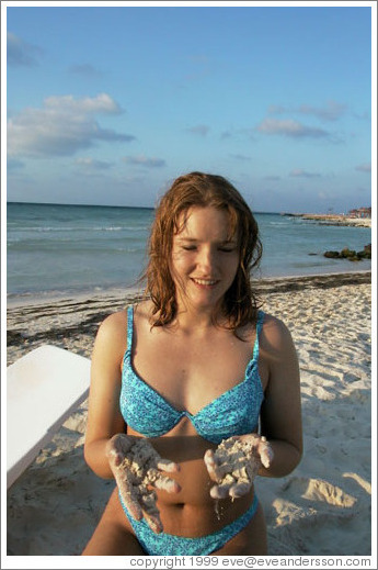 Eve gets her jollies playing in the sand.