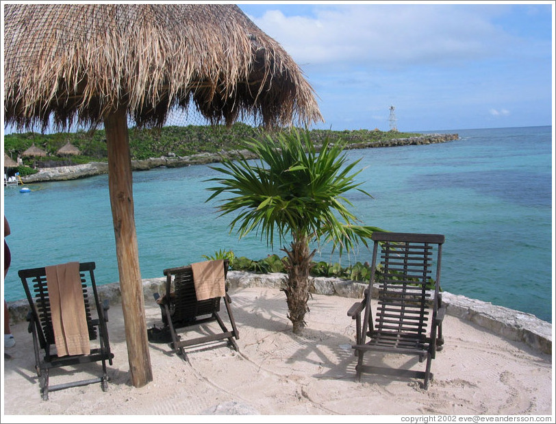 Beach scene.  Lighthouse in background.