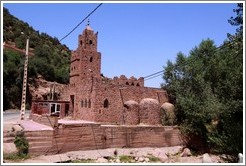 Mosque made of stone on the side of a mountain road.